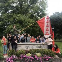 Charlie Holguin and his TKE brothers raise the fraternity's flag at the main Beloit College sign at Chapin and College Streets. — Submi...