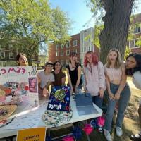 Members of Fem Co at Involvement Fair table.